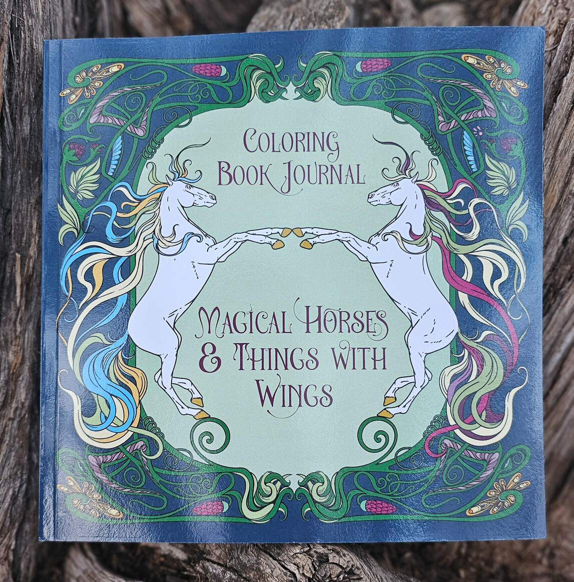 Image of Yoga Unicorn meditating in a bed of flowers.